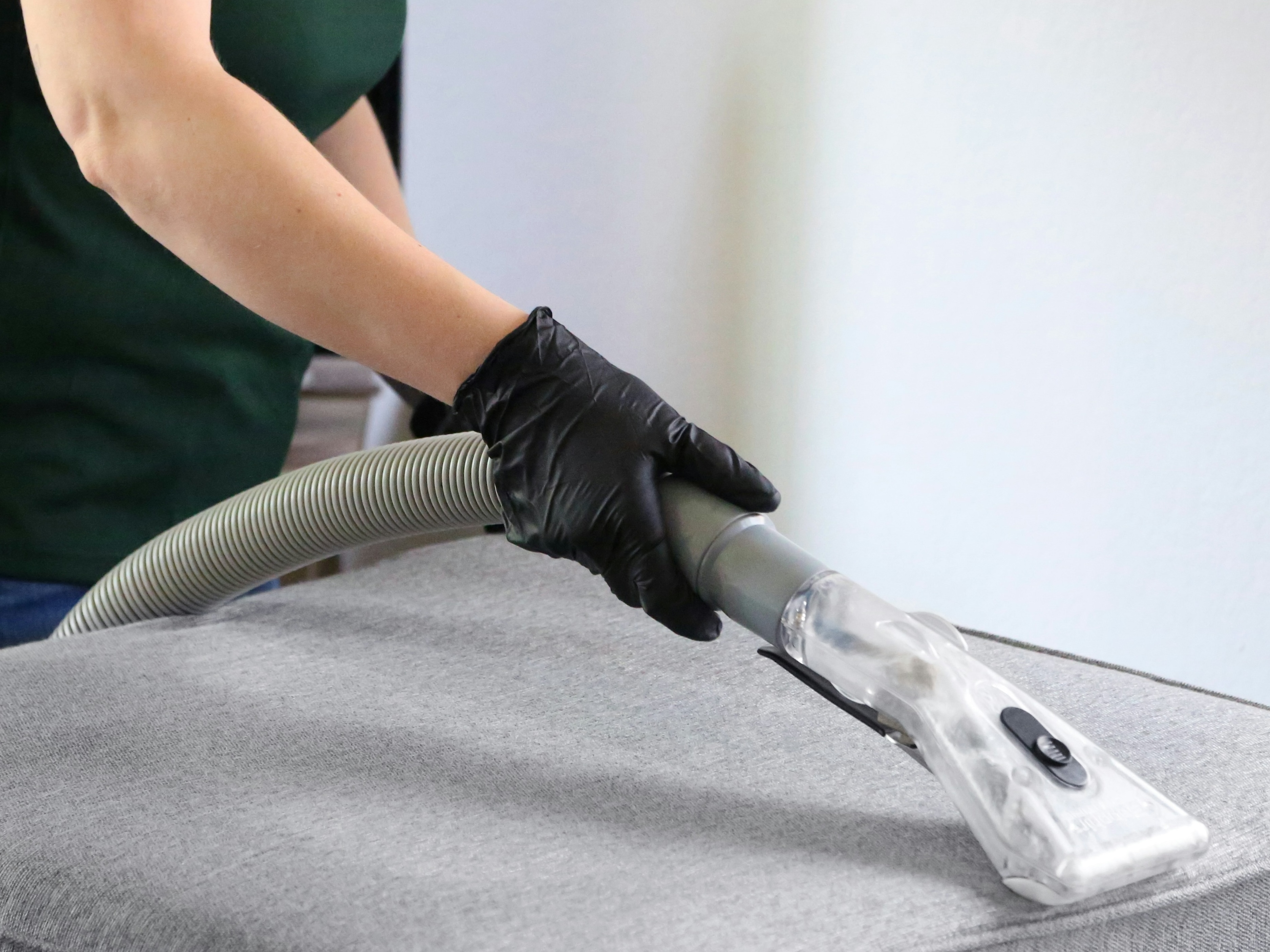 Cleaning specialist mopping hardwood floor a bright, clean home