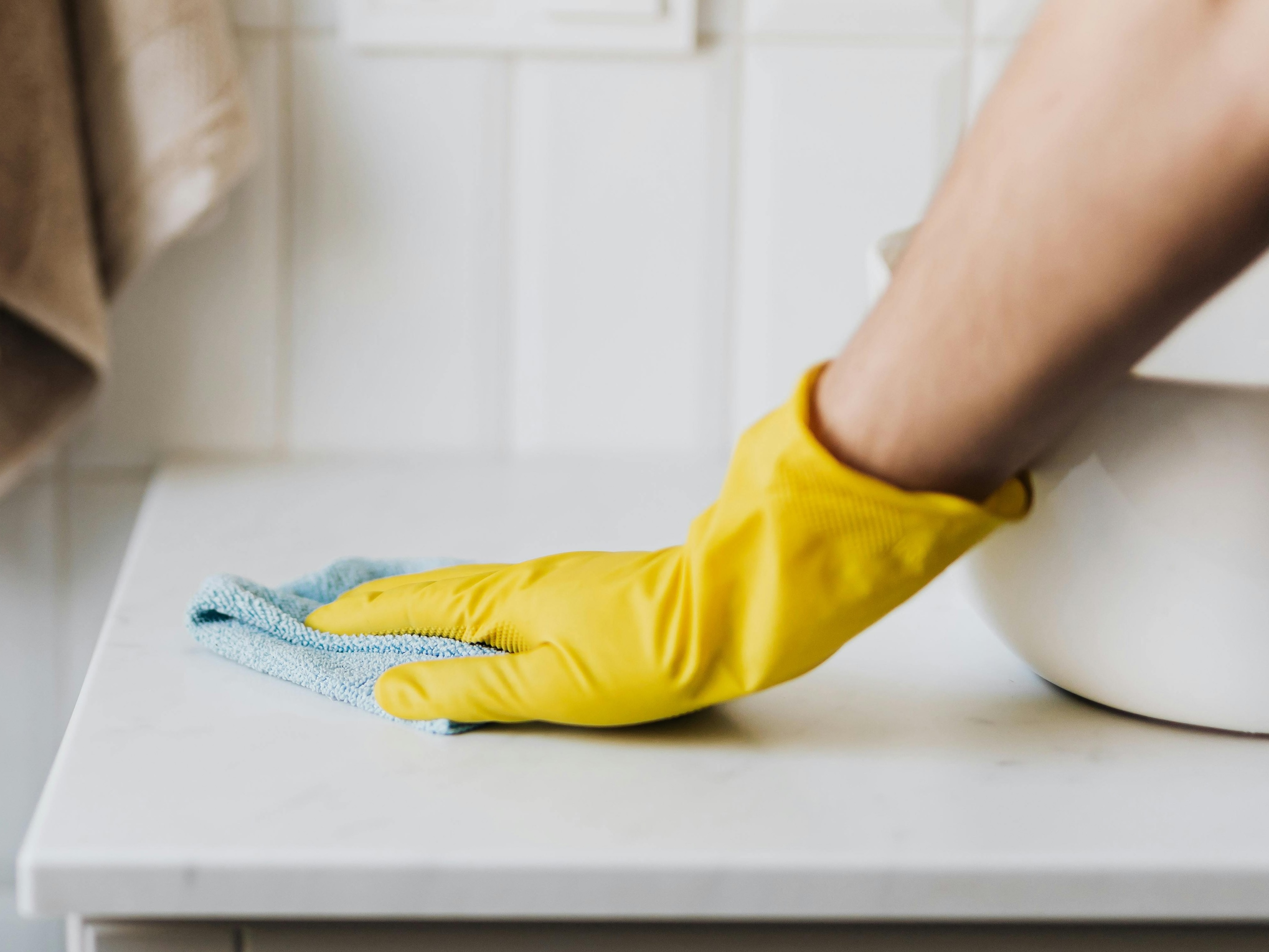 Woman cleaning windows with cleaner and a clean cloth